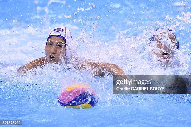 Russia's Ekaterina Prokofyeva and Italy's Rosaria Aiello vie for the ball during their Rio 2016 Olympic Games women's water polo semifinal game at...