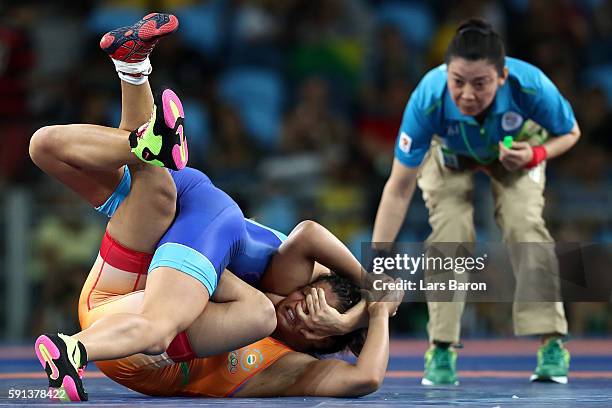 Sakshi Malik of India competes against Valeriia Koblova Zholobova of Russia during a Women's Freestyle 58kg Quarterfinal bout on Day 12 of the Rio...