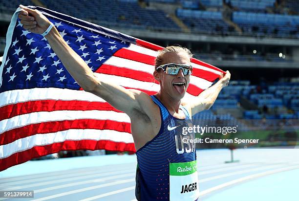 Evan Jager of the United States celebrates with the American flag after winning the silver medal in the Men's 3000m Steeplechase Final on Day 12 of...