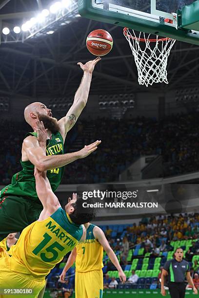 Lithuania's centre Antanas Kavaliauskas goes to the basket over Australia's guard Damian Martin during a Men's quarterfinal basketball match between...