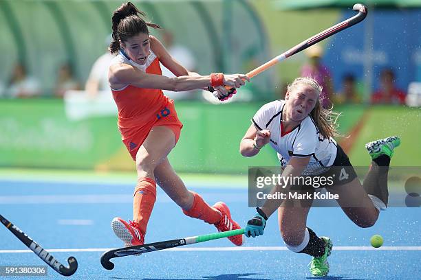 Naomi van As of the Netherlands shoots at goal under pressure from Nike Lorenz of Germany who was hit on the head with her stick during the womens...