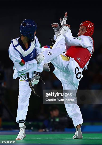 Rui Braganca of Portugal competes against Oscar Luis Munoz Oviedo of Colombia during the Taekwondo Men's -58kg Round One contest on Day 11 of the Rio...