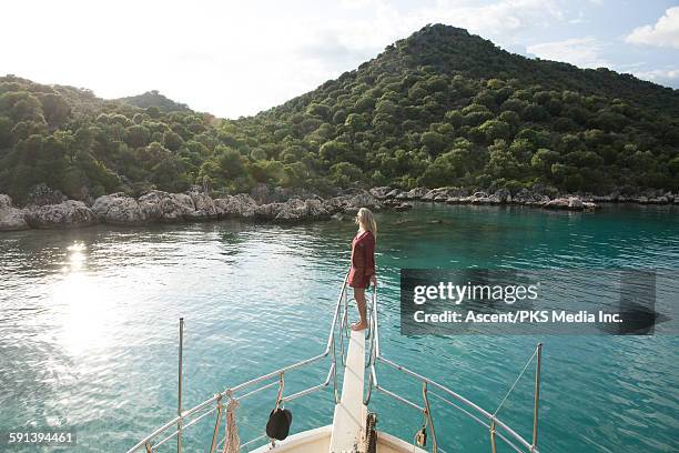 woman looks out across sea from bowsprit - アンタルヤ県 ストックフォトと画像