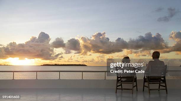 couple sat in chairs on devck of boat - maldives boat stock pictures, royalty-free photos & images