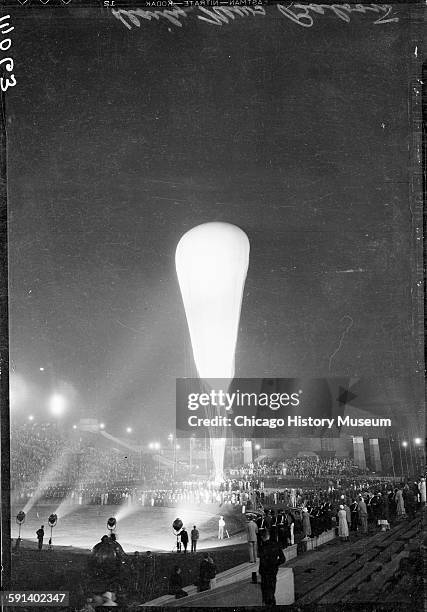 Crowds watch Auguste Piccard inflating the Stratosphere Balloon for flight in Soldier Field at the 1933 Chicago World's Fair, A Century of Progress...