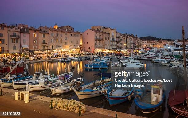 fishing boats and luxury yachts in the port of st tropez at sunset, provence, france - saint tropez stock pictures, royalty-free photos & images