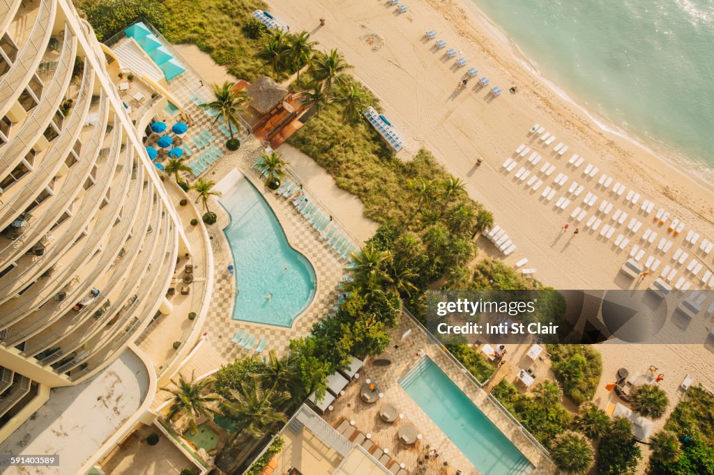 Aerial view of hotel pools and tropical beach