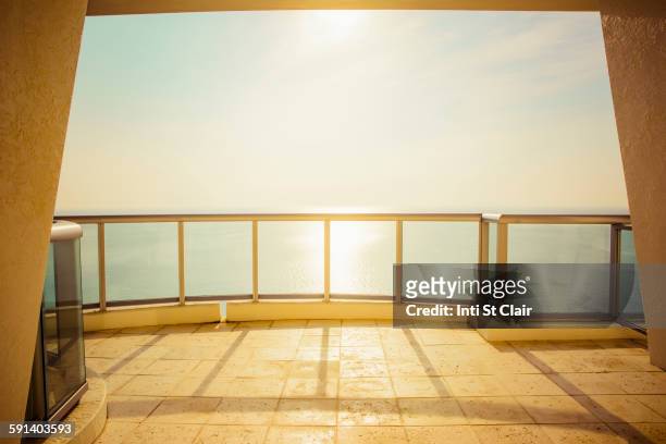 balcony overlooking ocean and sunny sky - looking over balcony stock pictures, royalty-free photos & images