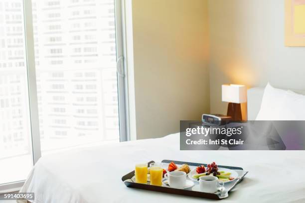breakfast tray on hotel bed - room service stock pictures, royalty-free photos & images