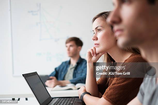 student listening in college classroom - students work foto e immagini stock