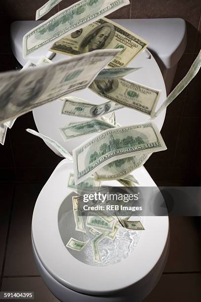 dollar bills falling into toilet - flush money stock pictures, royalty-free photos & images