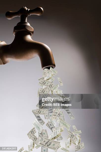 dollar bills pouring out of faucet - water pouring down stock pictures, royalty-free photos & images