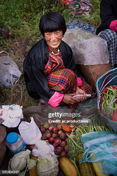 asian woman smiling at market - thimphu 個照片及圖片檔