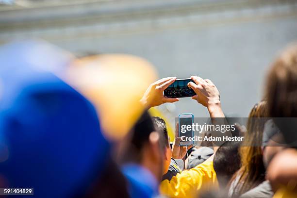 crowd of fans photographing sporting event - evento deportivo fotografías e imágenes de stock