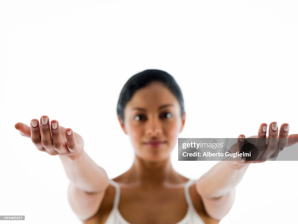Close up of woman meditating with arms outstretched