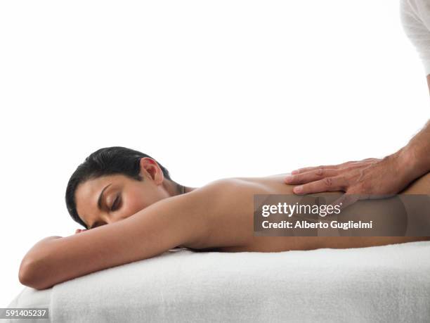 woman having back massage - massage table white background stock pictures, royalty-free photos & images