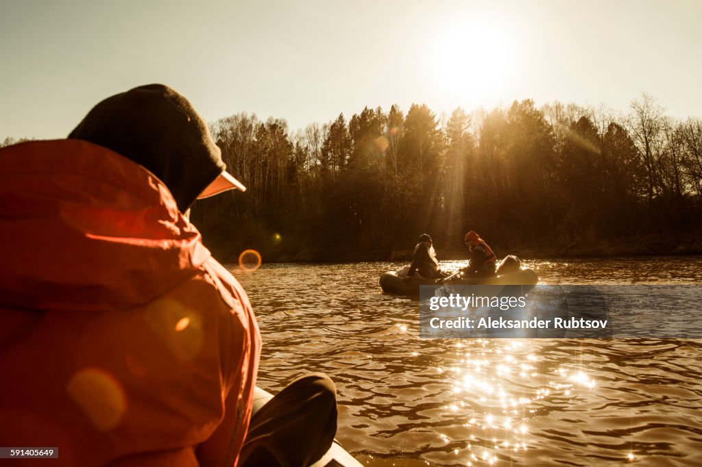 Caucasian fisherman sitting in canoe on river