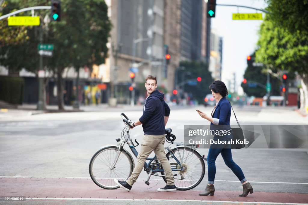 Caucasian business people crossing city street