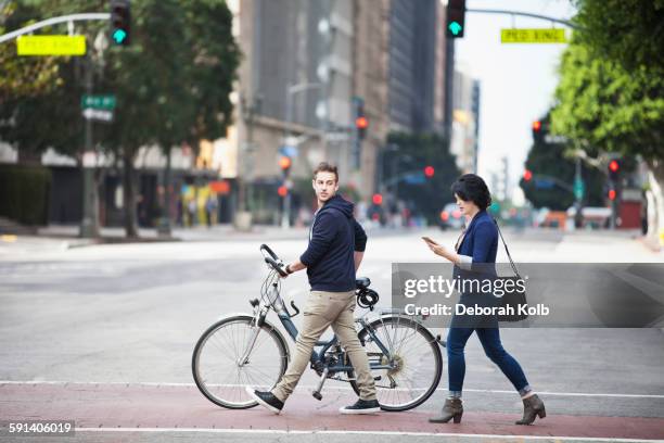 caucasian business people crossing city street - couple crossing street stock pictures, royalty-free photos & images