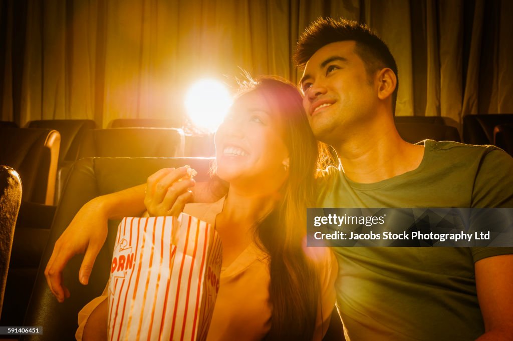 Chinese couple watching film in movie theater