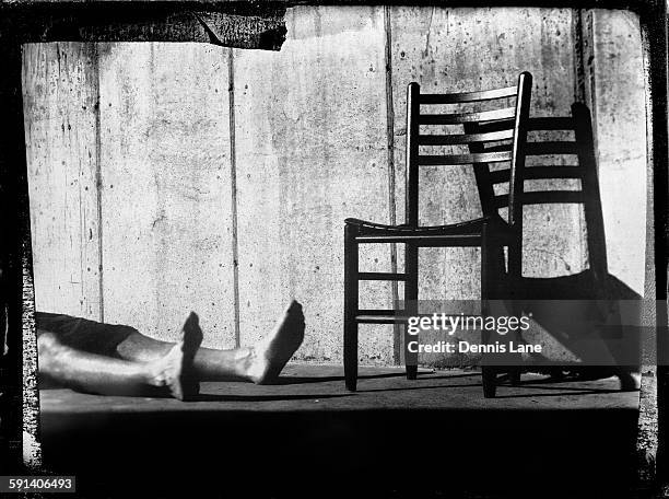 legs laying by chair on sidewalk - daguerreotype stock pictures, royalty-free photos & images