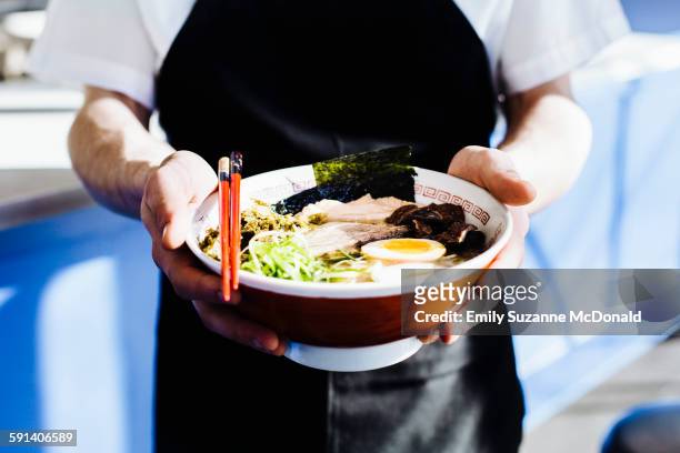 chef holding bowl of ramen in restaurant - ramen noodles stock pictures, royalty-free photos & images
