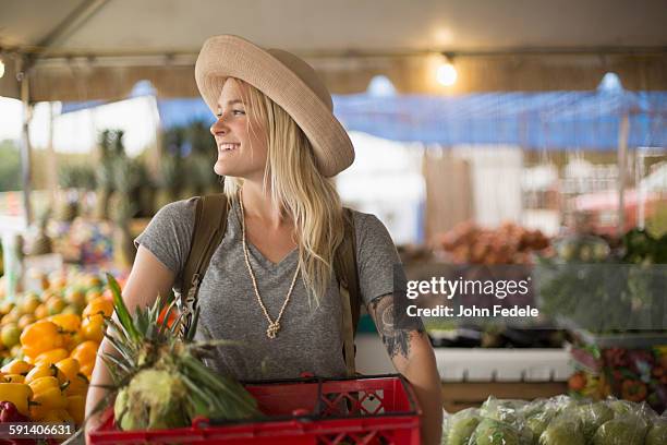 caucasian woman shopping for produce in farmers market - farm produce market stock pictures, royalty-free photos & images