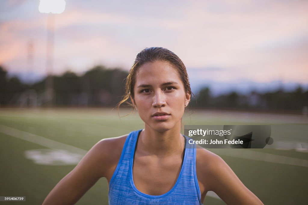 Mixed race athlete standing on sports field