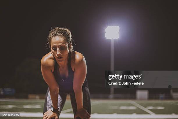 caucasian athlete resting on sports field - athlete stock pictures, royalty-free photos & images