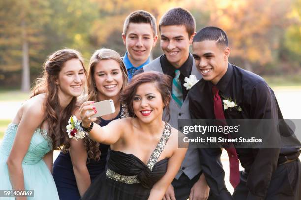 teenagers taking selfie with cell phone before prom - ballo di fine anno scolastico foto e immagini stock