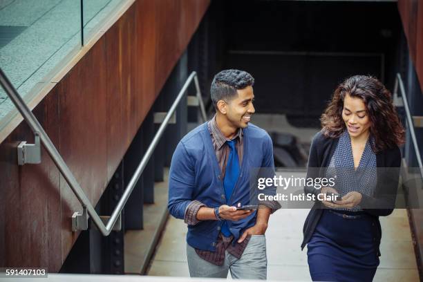 business people using cell phones on office steps - indian colleague stock pictures, royalty-free photos & images