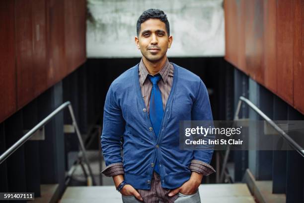 indian businessman standing on office steps - new york personas stock-fotos und bilder