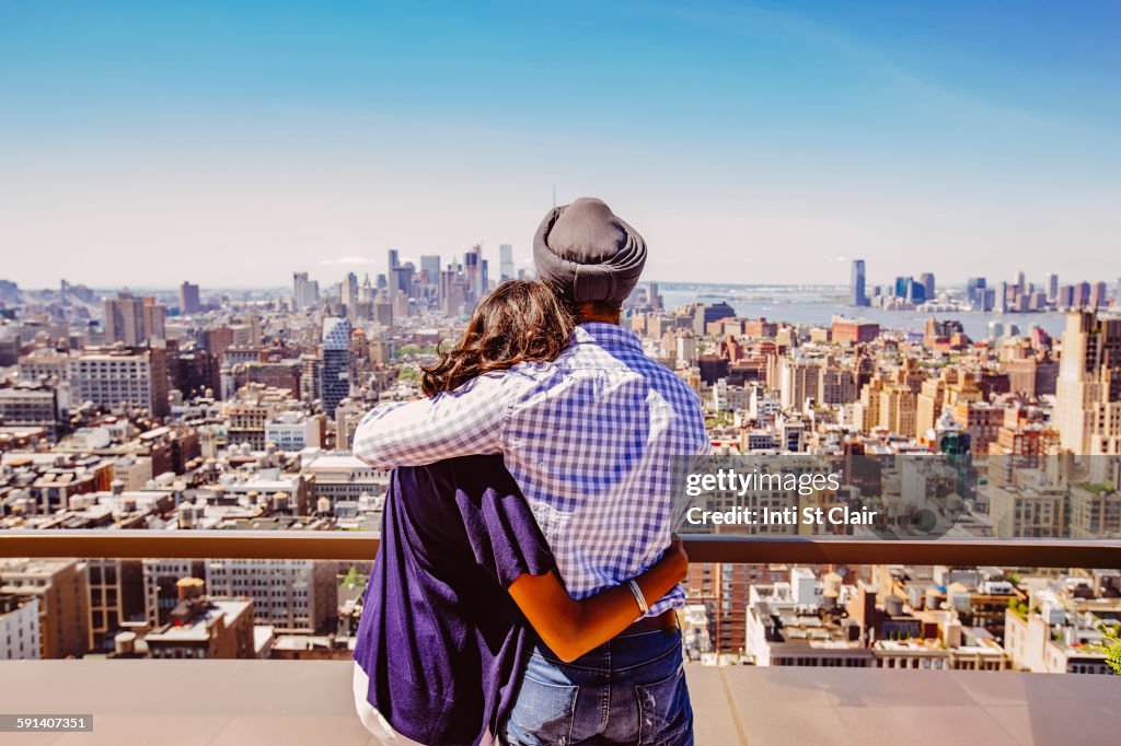 Indian couple admiring New York cityscape, New York, United States