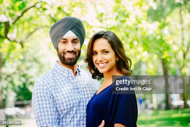 indian couple hugging in urban park - turban stock pictures, royalty-free photos & images