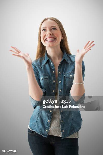 smiling caucasian woman cheering - gestikulieren stock-fotos und bilder
