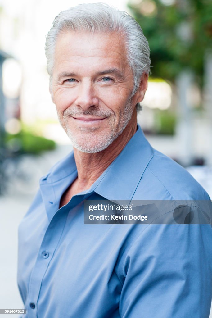 Caucasian businessman smiling outdoors