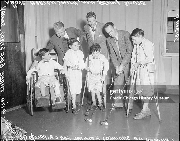 Children from Shriners Hospital for Crippled Children with golfers Sandy Armour, Horton Smith, and Denny Shute, Chicago, Illinois, June 1935.