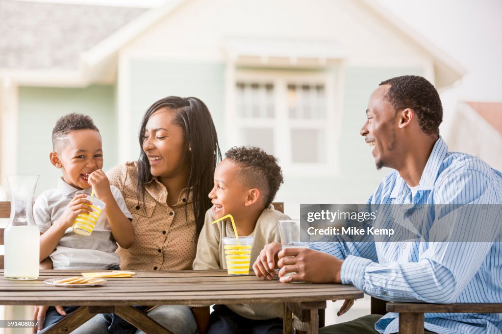 Family drinking juice in backyard