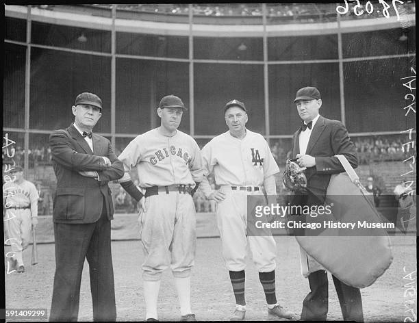 Baseball managers Jack Lelivelt of the Los Angeles Angels and Lew Fonseca of the Chicago White Sox, standing between two umpires, 1934.