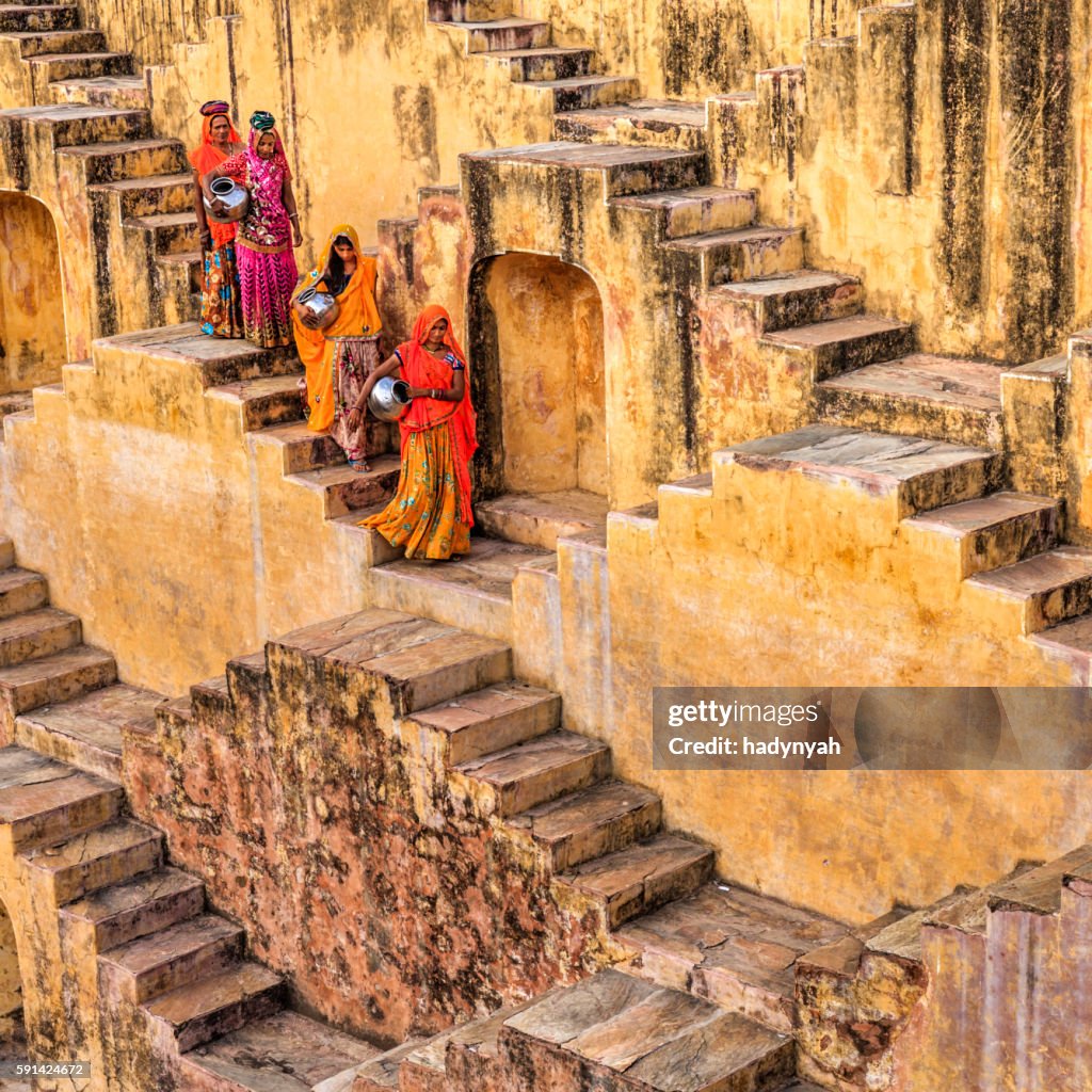 Indian women carrying water from stepwell near Jaipur