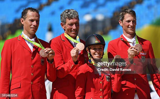 Bronze medalists Christian Ahlmann of Germany riding Taloubet Z, Ludger Beerbaum of Germany riding Casello, Meredith Michaels-Beerbaum of Germany...