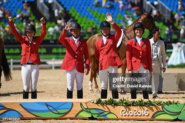 Silver medalists Lucy Davis of United States riding Barron, Kent Farrington of the United States riding Voyeur, McLain Ward of United States riding...