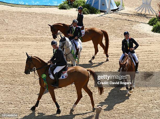 Gold medalists Roger Yves Bost of France riding Sydney Une Prince, Penelope Leprevost of France riding Flora de Mariposa, Kevin Staut of France...