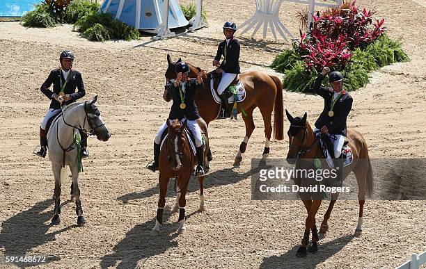 Gold medalists Roger Yves Bost of France riding Sydney Une Prince, Penelope Leprevost of France riding Flora de Mariposa, Kevin Staut of France...