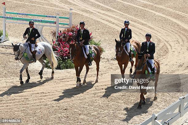 Gold medalists Roger Yves Bost of France riding Sydney Une Prince, Penelope Leprevost of France riding Flora de Mariposa, Kevin Staut of France...