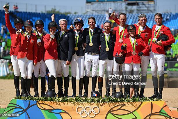 Silver medalists McLain Ward of United States riding Azur, Lucy Davis of United States riding Barron, Kent Farrington of the United States riding...