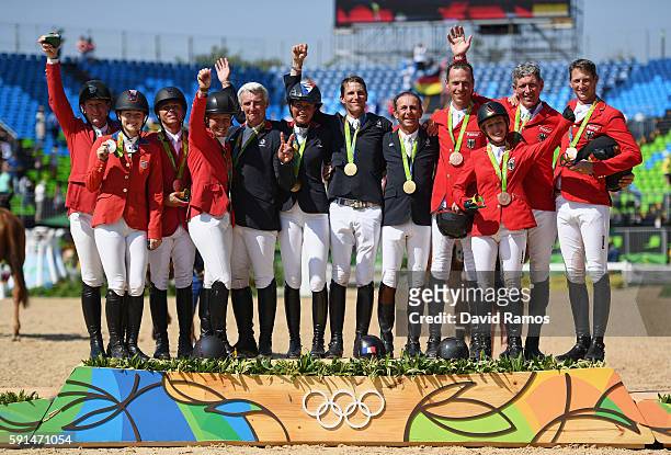 Silver medalists McLain Ward of United States riding Azur, Lucy Davis of United States riding Barron, Kent Farrington of the United States riding...