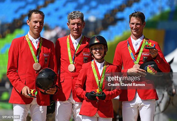 Bronze medalists Christian Ahlmann of Germany riding Taloubet Z, Ludger Beerbaum of Germany riding Casello, Meredith Michaels-Beerbaum of Germany...