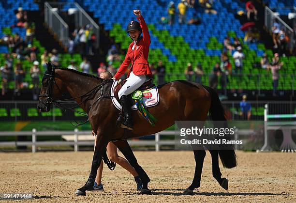 Silver medalist Lucy Davis of United States riding Barron celebrates before the medal ceremony after the Jumping Team competition on Day 12 of the...