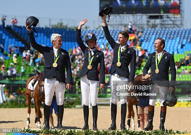 Gold medalists Roger Yves Bost of France riding Sydney Une Prince, Penelope Leprevost of France riding Flora de Mariposa, Kevin Staut of France...